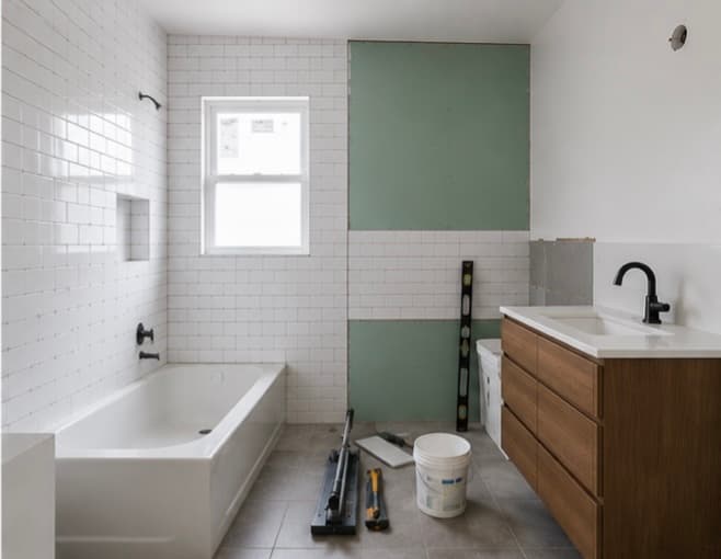 Bathroom mid-renovation with tile work in progress